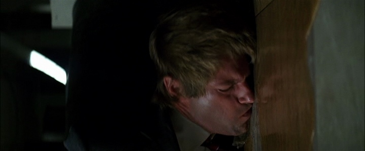 Le début de la mort symbolique d'Harvey Dent (Aaron Eckhart) dans The Dark Knight, dont on remarque le reflet dans la flaque d'essence qui annonce Double Face.